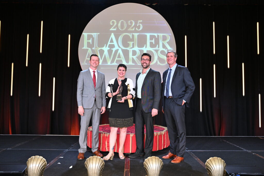 Nerissa Okiye and Ian Centrone accepting the 2025 Flagler Award from VISIT FLORIDA.